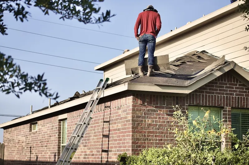 Professional roofer working on a residential roof in Lake Villa